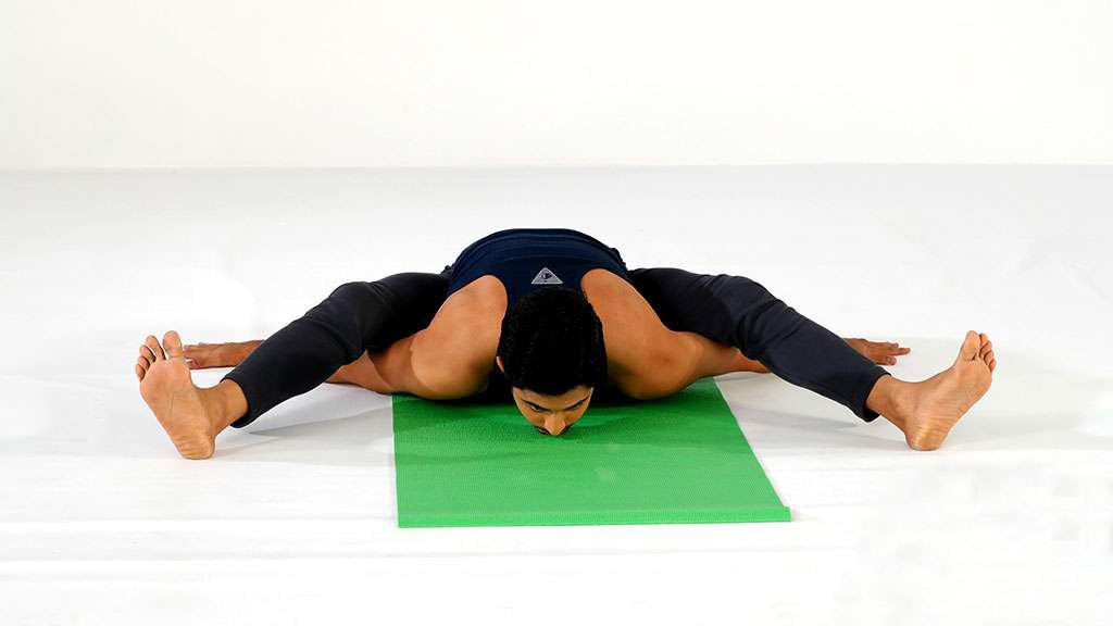 Beautiful sporty man practicing yoga. Asana Kurmasana. Tortoise pose.  Tortoise posture Stock Photo - Alamy